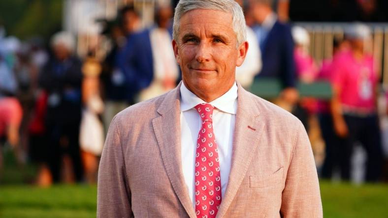 Aug 27, 2023; Atlanta, Georgia, USA; PGA TOUR commissioner Jay Monahan waits on the 18th green during the final round of the TOUR Championship golf tournament at East Lake Golf Club. Mandatory Credit: John David Mercer-USA TODAY Sports