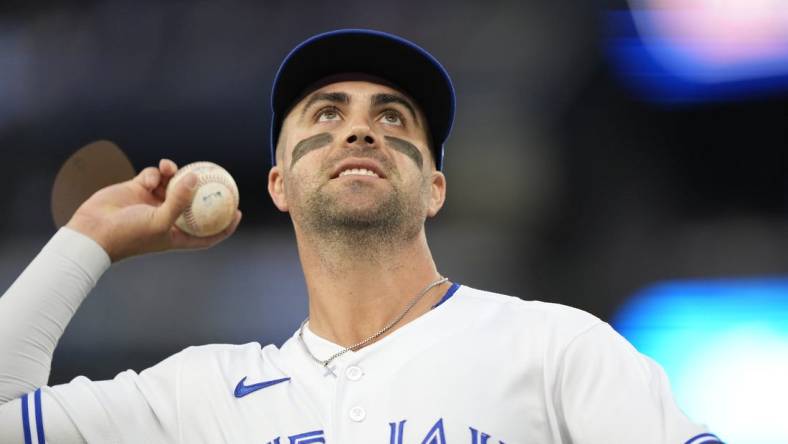 Sep 8, 2023; Toronto, Ontario, CAN; Toronto Blue Jays second baseman Whit Merrifield (15) goes to throw a ball to a fan during the second inning against the Kansas City Royals at Rogers Centre. Mandatory Credit: John E. Sokolowski-USA TODAY Sports