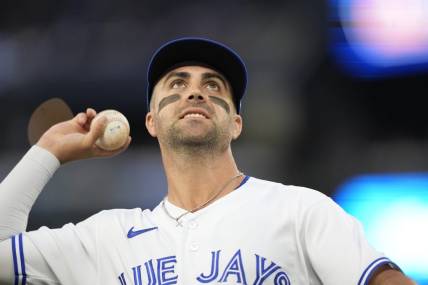 Sep 8, 2023; Toronto, Ontario, CAN; Toronto Blue Jays second baseman Whit Merrifield (15) goes to throw a ball to a fan during the second inning against the Kansas City Royals at Rogers Centre. Mandatory Credit: John E. Sokolowski-USA TODAY Sports