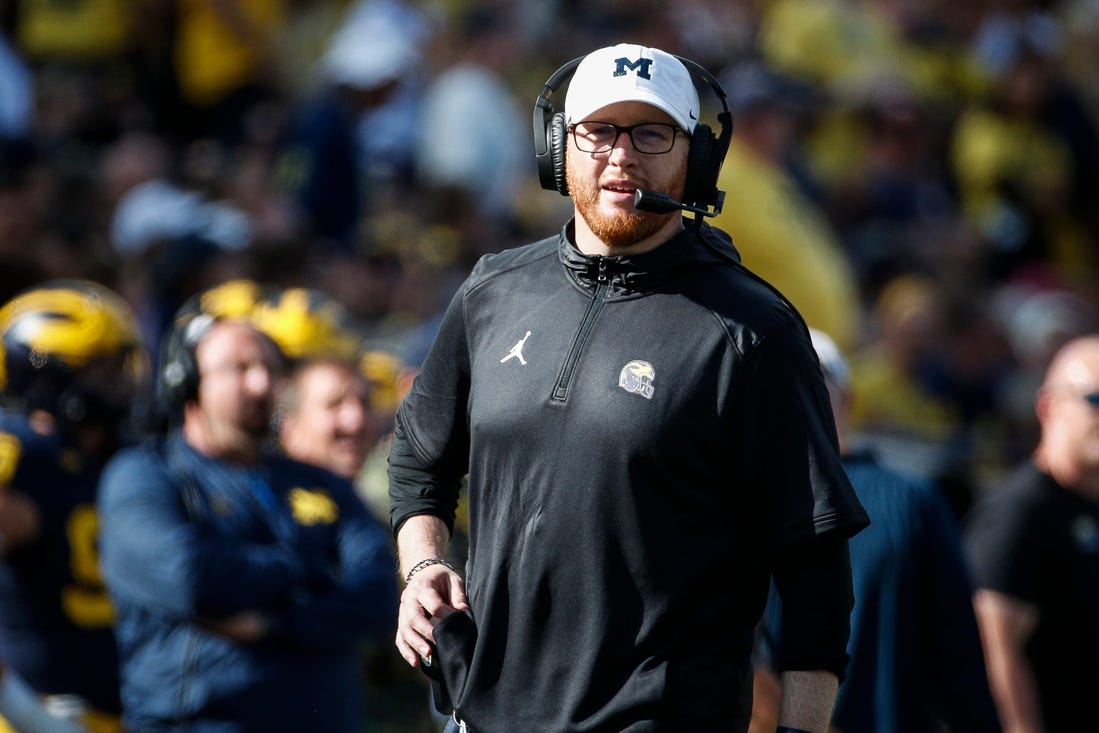 Michigan acting head coach Jay Harbaugh talks to players at a timeout against UNLV during the first half at Michigan Stadium in Ann Arbor on Saturday, Sept. 9, 2023.