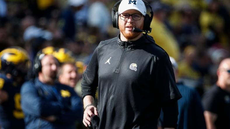 Michigan acting head coach Jay Harbaugh talks to players at a timeout against UNLV during the first half at Michigan Stadium in Ann Arbor on Saturday, Sept. 9, 2023.