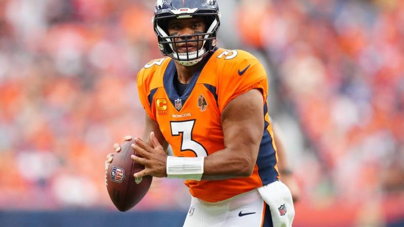 Sep 10, 2023; Denver, Colorado, USA; Denver Broncos quarterback Russell Wilson (3) prepares to pass to wide receiver Courtland Sutton (14) (not pictured) who scored a touchdown in the second quarter against the Las Vegas Raiders at Empower Field at Mile High. Mandatory Credit: Ron Chenoy-USA TODAY Sports