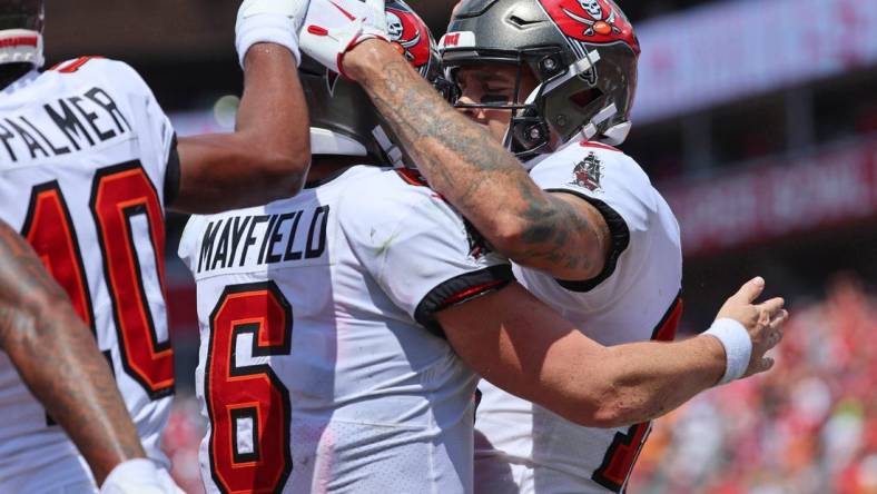 Sep 17, 2023; Tampa, Florida, USA; Tampa Bay Buccaneers wide receiver Mike Evans (13) is congratulated by quarterback Baker Mayfield (6) after scoring a touchdown against the Chicago Bears during the second half at Raymond James Stadium. Mandatory Credit: Kim Klement Neitzel-USA TODAY Sports