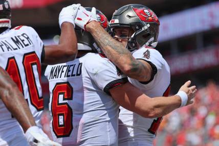 Sep 17, 2023; Tampa, Florida, USA; Tampa Bay Buccaneers wide receiver Mike Evans (13) is congratulated by quarterback Baker Mayfield (6) after scoring a touchdown against the Chicago Bears during the second half at Raymond James Stadium. Mandatory Credit: Kim Klement Neitzel-USA TODAY Sports