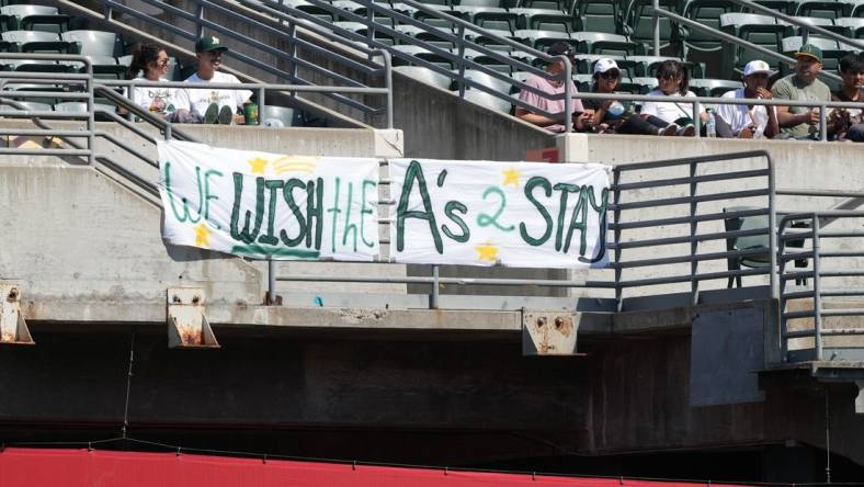 Sep 17, 2023; Oakland, California, USA; Oakland Athletics fans hang a sign in the right field bleachers during the fourth inning against the San Diego Padres at Oakland-Alameda County Coliseum. Mandatory Credit: Darren Yamashita-USA TODAY Sports