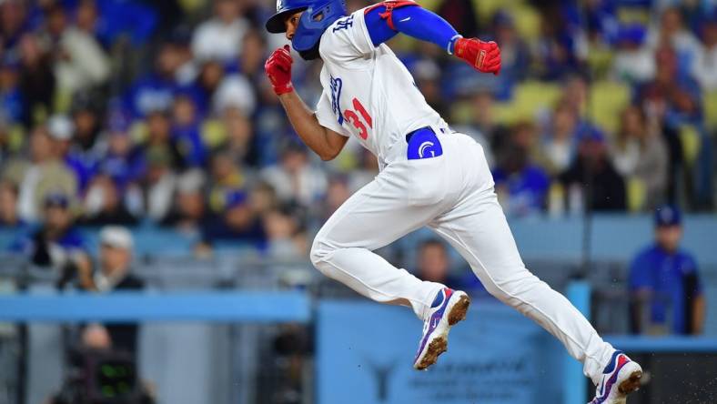 Sep 21, 2023; Los Angeles, California, USA; Los Angeles Dodgers second baseman Amed Rosario (31) runs after hitting a single against the San Francisco Giants during the fourth inning at Dodger Stadium. Mandatory Credit: Gary A. Vasquez-USA TODAY Sports