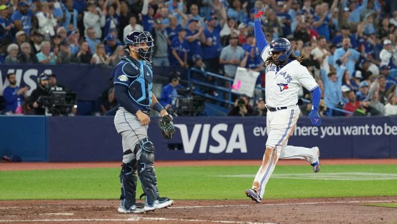 Sep 29, 2023; Toronto, Ontario, CAN; Toronto Blue Jays first baseman Vladimir Guerrero Jr. (27) runs to home plate scoring a run against the Tampa Bay Rays during the sixth inning at Rogers Centre. Mandatory Credit: Nick Turchiaro-USA TODAY Sports