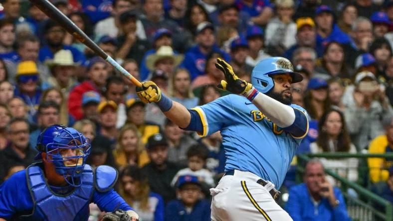 Sep 29, 2023; Milwaukee, Wisconsin, USA;  Milwaukee Brewers first baseman Carlos Santana (41) hits a RBI triple against the Chicago Cubs in the fifth inning at American Family Field. Mandatory Credit: Benny Sieu-USA TODAY Sports