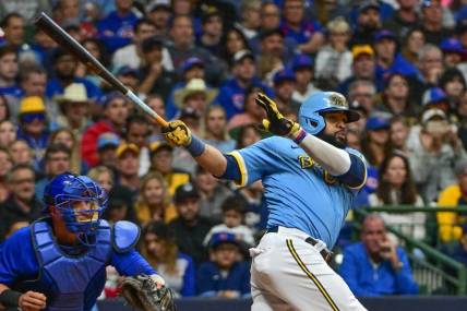 Sep 29, 2023; Milwaukee, Wisconsin, USA;  Milwaukee Brewers first baseman Carlos Santana (41) hits a RBI triple against the Chicago Cubs in the fifth inning at American Family Field. Mandatory Credit: Benny Sieu-USA TODAY Sports