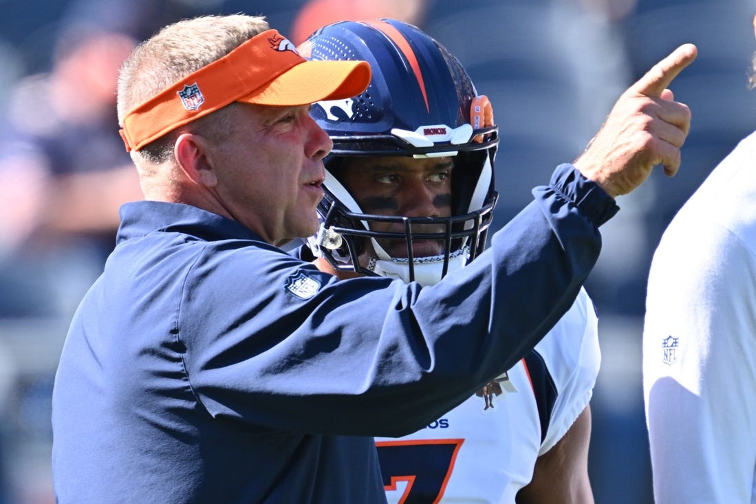 Oct 1, 2023; Chicago, Illinois, USA;  Denver Broncos head coach Sean Payton talks with quarterback Russell Wilson (3) before a game against the Chicago Bears at Soldier Field. Mandatory Credit: Jamie Sabau-USA TODAY Sports