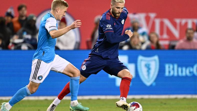 Oct 7, 2023; Chicago, Illinois, USA;  Chicago Fire FC forward Kacper Przybylko (11) controls the ball against Charlotte FC defender Jere Uronen (3) in the second half at Soldier Field. Mandatory Credit: Jamie Sabau-USA TODAY Sports