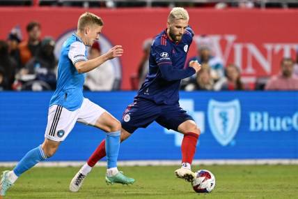 Oct 7, 2023; Chicago, Illinois, USA;  Chicago Fire FC forward Kacper Przybylko (11) controls the ball against Charlotte FC defender Jere Uronen (3) in the second half at Soldier Field. Mandatory Credit: Jamie Sabau-USA TODAY Sports