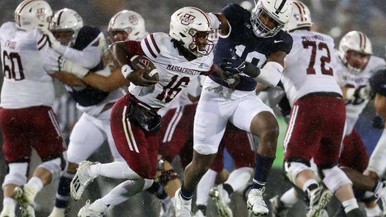 Oct 14, 2023; University Park, Pennsylvania, USA; Penn State Nittany Lions defensive end Jameial Lyons (19) pressures Massachusetts Minutemen quarterback Ahmad Haston (16) during the fourth quarter at Beaver Stadium. Penn State defeated Massachusetts 63-0. Mandatory Credit: Matthew O'Haren-USA TODAY Sports