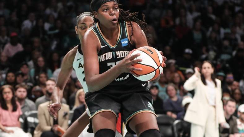 Oct 15, 2023; Brooklyn, New York, USA; New York Liberty forward Jonquel Jones (35) grabs a rebound against the Las Vegas Aces in the second quarter during game three of the 2023 WNBA Finals at Barclays Center. Mandatory Credit: Wendell Cruz-USA TODAY Sports