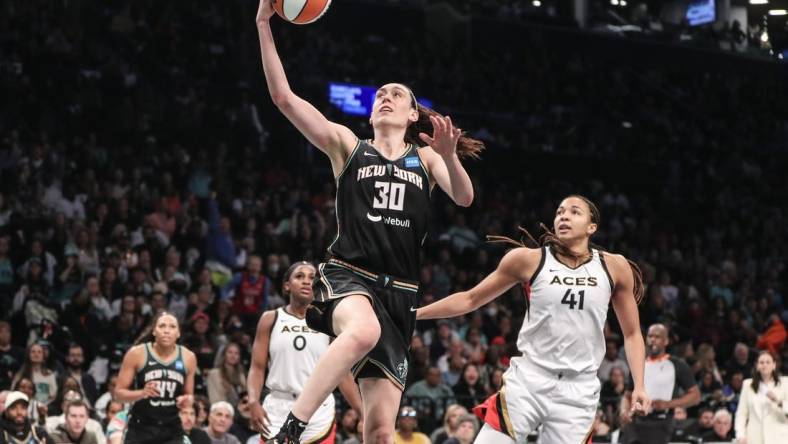 Oct 15, 2023; Brooklyn, New York, USA; New York Liberty forward Breanna Stewart (30) drives past Las Vegas Aces center Kiah Stokes (41) for a layup in the third quarter during game three of the 2023 WNBA Finals at Barclays Center. Mandatory Credit: Wendell Cruz-USA TODAY Sports