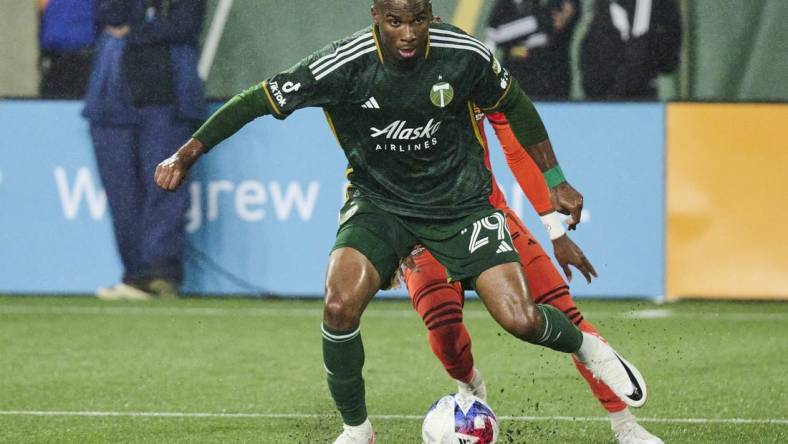 Oct 21, 2023; Portland, Oregon, USA; Portland Timbers defender Juan David Mosquera (29) steals the ball away from Houston Dynamo forward Nelson Quinones (21) during the second half at Providence Park. Mandatory Credit: Troy Wayrynen-USA TODAY Sports