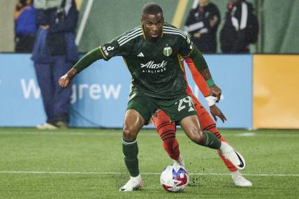 Oct 21, 2023; Portland, Oregon, USA; Portland Timbers defender Juan David Mosquera (29) steals the ball away from Houston Dynamo forward Nelson Quinones (21) during the second half at Providence Park. Mandatory Credit: Troy Wayrynen-USA TODAY Sports