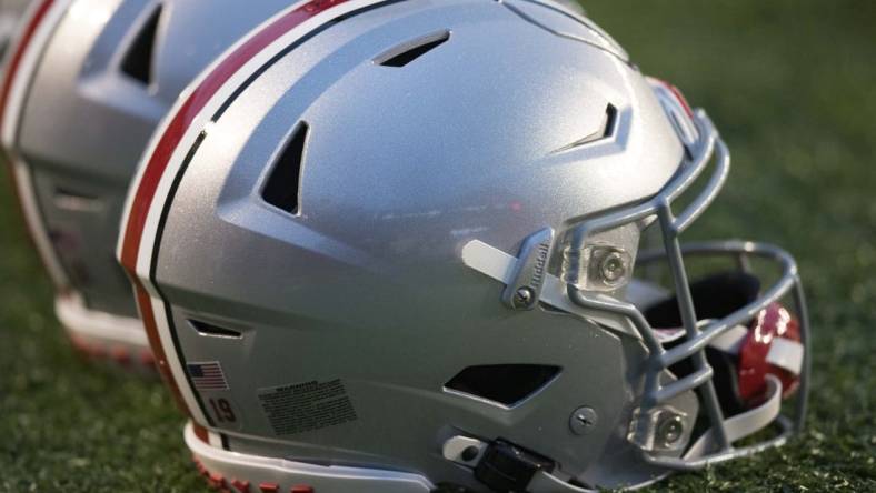 Oct 28, 2023; Madison, Wisconsin, USA;  Ohio State Buckeyes helmets sit on the field during warmups prior to the game against the Wisconsin Badgers at Camp Randall Stadium. Mandatory Credit: Jeff Hanisch-USA TODAY Sports