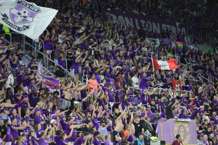 Oct 30, 2023; Orlando, Florida, USA; Orlando City fans celebrate in the second half against the Nashville SC of game one in a round one match of the 2023 MLS Cup Playoffs at Exploria Stadium. Mandatory Credit: Nathan Ray Seebeck-USA TODAY Sports