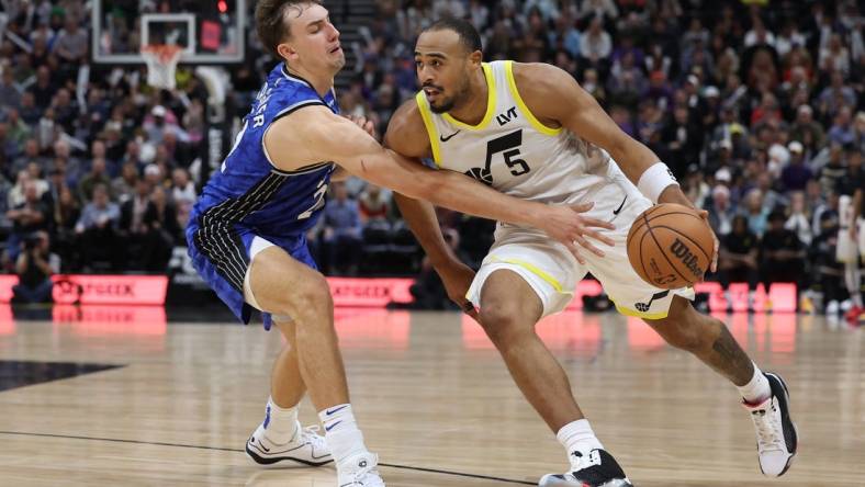 Nov 2, 2023; Salt Lake City, Utah, USA; Utah Jazz guard Talen Horton-Tucker (5) drives against Orlando Magic forward Franz Wagner (22) in the fourth quarter at the Delta Center. Mandatory Credit: Rob Gray-USA TODAY Sports