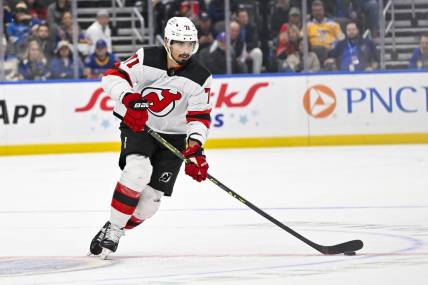 Nov 3, 2023; St. Louis, Missouri, USA;  New Jersey Devils defenseman Jonas Siegenthaler (71) controls the puck against the St. Louis Blues during the first period at Enterprise Center. Mandatory Credit: Jeff Curry-USA TODAY Sports