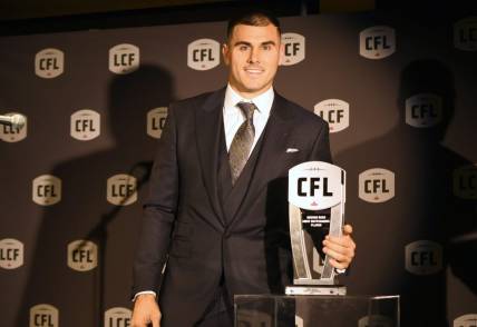 Nov 16, 2023; Niagra Falls, Ontario, CAN;  Toronto Argonauts quarterback Chad Kelly poses with the trophy after winning the George Reed Most Outstanding Player during the CFL Awards at Fallsview Casino & Resort. Mandatory Credit: Dan Hamilton-USA TODAY Sports
