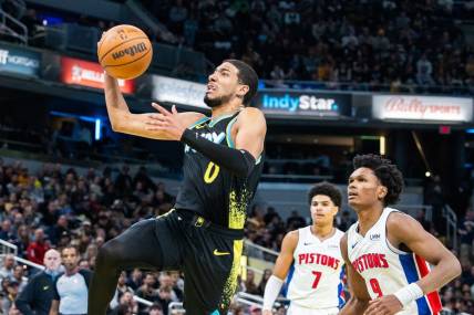 Nov 24, 2023; Indianapolis, Indiana, USA; Indiana Pacers guard Tyrese Haliburton (0) shoots the ball while Detroit Pistons forward Ausar Thompson (9) defends in the second half at Gainbridge Fieldhouse. Mandatory Credit: Trevor Ruszkowski-USA TODAY Sports