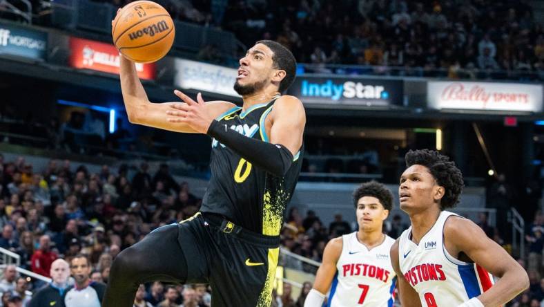 Nov 24, 2023; Indianapolis, Indiana, USA; Indiana Pacers guard Tyrese Haliburton (0) shoots the ball while Detroit Pistons forward Ausar Thompson (9) defends in the second half at Gainbridge Fieldhouse. Mandatory Credit: Trevor Ruszkowski-USA TODAY Sports