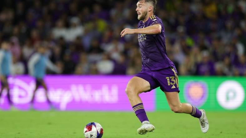 Nov 25, 2023; Orlando, Florida, USA; Orlando City forward Duncan McGuire (13) dribbles the ball against Columbus Crew during the first half in a MLS Cup Eastern Conference Semifinal match at Exploria Stadium. Mandatory Credit: Nathan Ray Seebeck-USA TODAY Sports