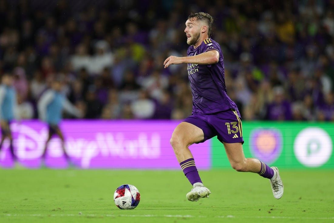 Nov 25, 2023; Orlando, Florida, USA; Orlando City forward Duncan McGuire (13) dribbles the ball against Columbus Crew during the first half in a MLS Cup Eastern Conference Semifinal match at Exploria Stadium. Mandatory Credit: Nathan Ray Seebeck-USA TODAY Sports