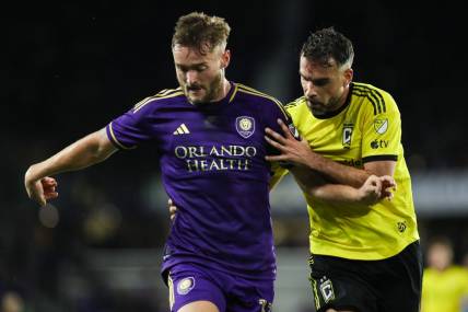 Nov 25, 2023; Orlando, Florida, USA; Orlando City forward Duncan McGuire (13) and Columbus Crew defender Rudy Camacho (4) battle for the ball during the second half in a MLS Cup Eastern Conference Semifinal match at Exploria Stadium. Mandatory Credit: Morgan Tencza-USA TODAY Sports