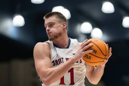 Nov 27, 2023; Moraga, California, USA;  St. Mary's Gaels center Mitchell Saxen (11) controls the ball during the second half against the Utah Utes at University Credit Union Pavilion. Mandatory Credit: Stan Szeto-USA TODAY Sports