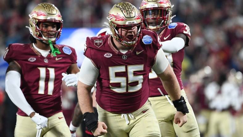 Dec 2, 2023; Charlotte, NC, USA; Florida State Seminoles defensive lineman Braden Fiske (55) reacts after a tackle on Louisville Cardinals running back Jawhar Jordan (25) in the first quarter at Bank of America Stadium. Mandatory Credit: Bob Donnan-USA TODAY Sports