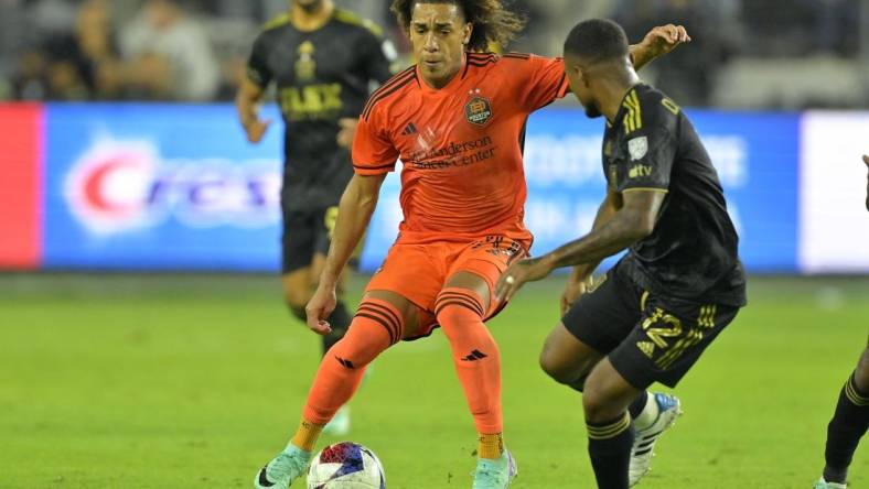 Dec 2, 2023; Los Angeles, California, USA; Houston Dynamo midfielder Adalberto Carrasquilla (20) kicks the ball past Los Angeles FC defender Diego Palacios (12) in the second half for the MLS Cup Western Conference Final at BMO Stadium. Mandatory Credit: Jayne Kamin-Oncea-USA TODAY Sports