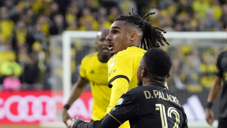 Dec 9, 2023; Columbus, OH, USA; Columbus Crew defender Mohamed Farsi (23) battles for the ball against Los Angeles FC defender Diego Palacios (12) in the first half during 2023 MLS CUP at Lower.com Field.