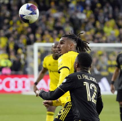 Dec 9, 2023; Columbus, OH, USA; Columbus Crew defender Mohamed Farsi (23) battles for the ball against Los Angeles FC defender Diego Palacios (12) in the first half during 2023 MLS CUP at Lower.com Field.