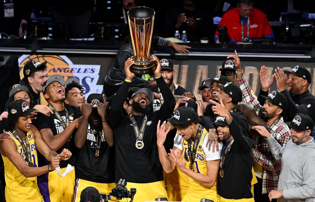 Dec 9, 2023; Las Vegas, Nevada, USA; Los Angeles Lakers forward LeBron James (23) hoists the NBA Cup and celebrates with teammates after winning the NBA In-Season Tournament Championship game against the Indiana Pacers at T-Mobile Arena. Mandatory Credit: Candice Ward-USA TODAY Sports