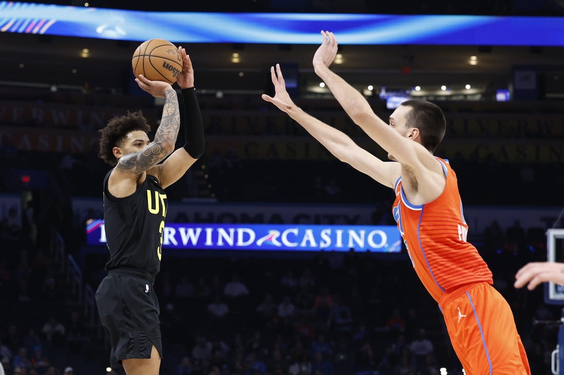 Dec 11, 2023; Oklahoma City, Oklahoma, USA; Utah Jazz guard Keyonte George (3) shoot a three-point basket as Oklahoma City Thunder forward Aleksej Pokusevski (17) defends during the second half at Paycom Center. Mandatory Credit: Alonzo Adams-USA TODAY Sports