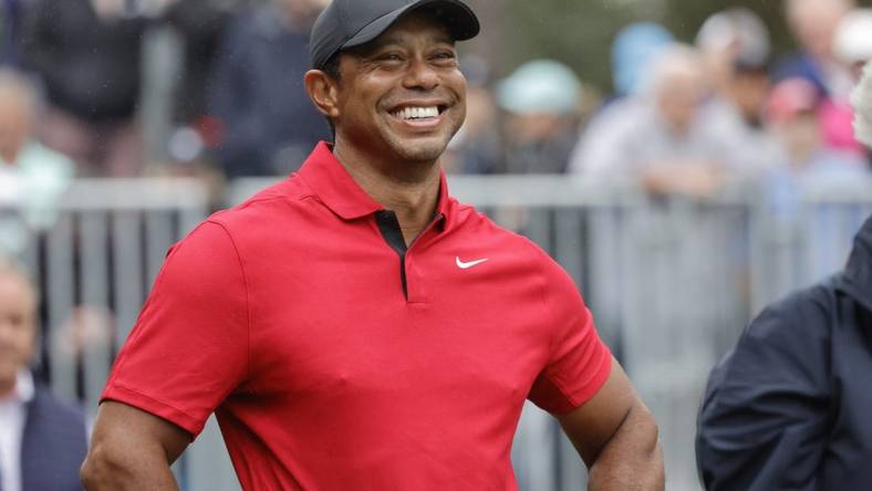 Dec 17, 2023; Orlando, Florida, USA;  Tiger Woods smiles before he plays his shot from the first tee during the PNC Championship at The Ritz-Carlton Golf Club. Mandatory Credit: Reinhold Matay-USA TODAY Sports