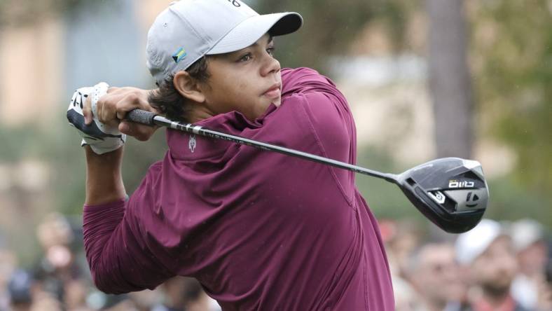 Dec 17, 2023; Orlando, Florida, USA;  Charlie Woods plays his shot from the first tee during the PNC Championship at The Ritz-Carlton Golf Club. Mandatory Credit: Reinhold Matay-USA TODAY Sports