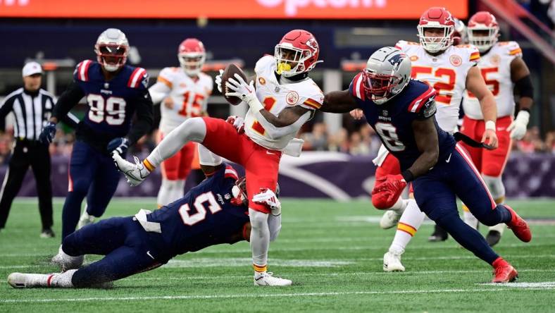 Dec 17, 2023; Foxborough, Massachusetts, USA; Kansas City Chiefs running back Jerick McKinnon (1) gets tackled by New England Patriots safety Jabrill Peppers (5) during the first half at Gillette Stadium. Mandatory Credit: Eric Canha-USA TODAY Sports