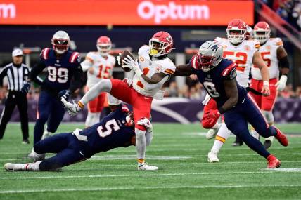 Dec 17, 2023; Foxborough, Massachusetts, USA; Kansas City Chiefs running back Jerick McKinnon (1) gets tackled by New England Patriots safety Jabrill Peppers (5) during the first half at Gillette Stadium. Mandatory Credit: Eric Canha-USA TODAY Sports