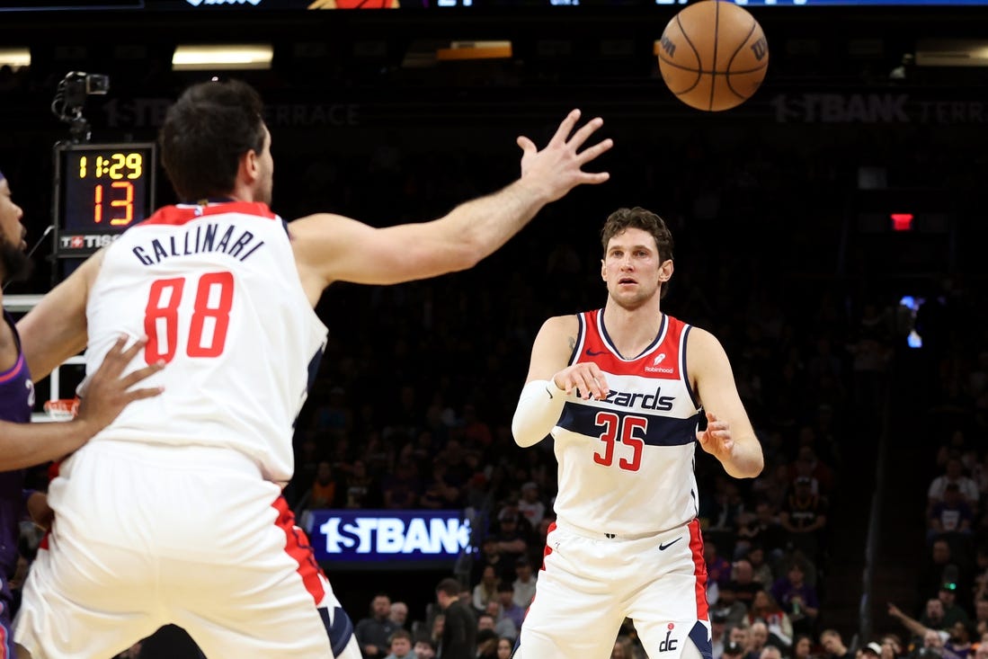 Dec 17, 2023; Phoenix, Arizona, USA; Washington Wizards center Mike Muscala (35) makes a pass to Washington Wizards forward Danilo Gallinari (88) against the Phoenix Suns during the first half at Footprint Center. Mandatory Credit: Zachary BonDurant-USA TODAY Sports