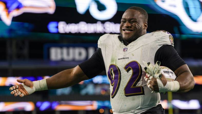 Dec 17, 2023; Jacksonville, Florida, USA;  Baltimore Ravens defensive tackle Justin Madubuike (92) celebrates after beating the Jacksonville Jaguars at EverBank Stadium. Mandatory Credit: Nathan Ray Seebeck-USA TODAY Sports