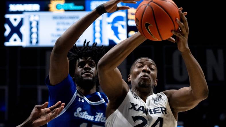 Xavier Musketeers forward Abou Ousmane (24) drops a pass as Seton Hall Pirates center Jaden Bediako (15) guards him in the second half of the basketball game between Xavier Musketeers and Seton Hall Pirates at the Cintas Center in Cincinnati on Saturday, Dec. 23, 2023.