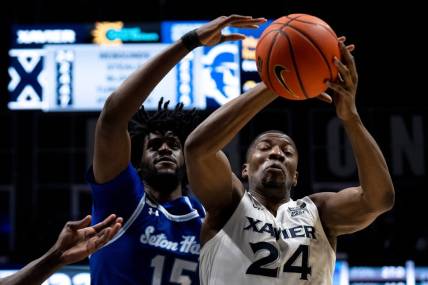 Xavier Musketeers forward Abou Ousmane (24) drops a pass as Seton Hall Pirates center Jaden Bediako (15) guards him in the second half of the basketball game between Xavier Musketeers and Seton Hall Pirates at the Cintas Center in Cincinnati on Saturday, Dec. 23, 2023.