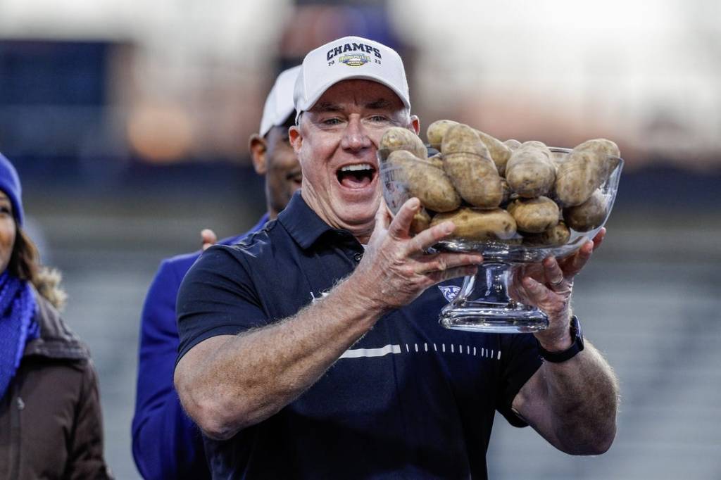 Dec 23, 2023; Boise, ID, USA; Georgia State Panthers head coach Shawn Elliott hoists the Famous Idaho Potato Bowl trophy after the game against the Utah State Aggies at Albertsons Stadium. Georgia State defeats Utah State 45-22. Mandatory Credit: Brian Losness-USA TODAY Sports