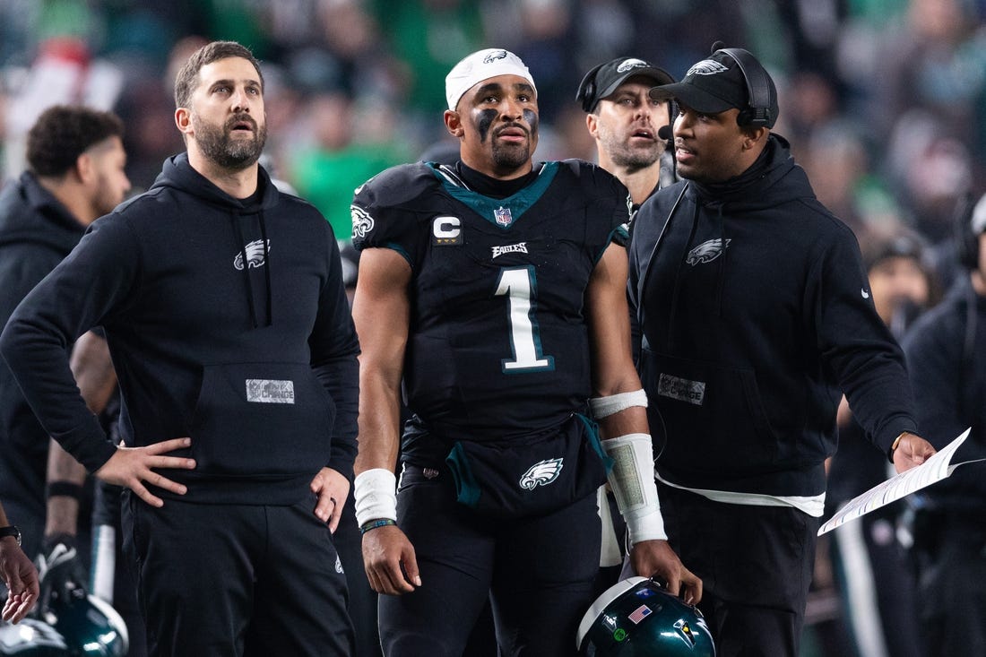Dec 25, 2023; Philadelphia, Pennsylvania, USA; Philadelphia Eagles head coach Nick Sirianni (L) and quarterback Jalen Hurts (1) and offensive coordinator Brian Johnson (R) talk during the second quarter against the New York Giants at Lincoln Financial Field. Mandatory Credit: Bill Streicher-USA TODAY Sports