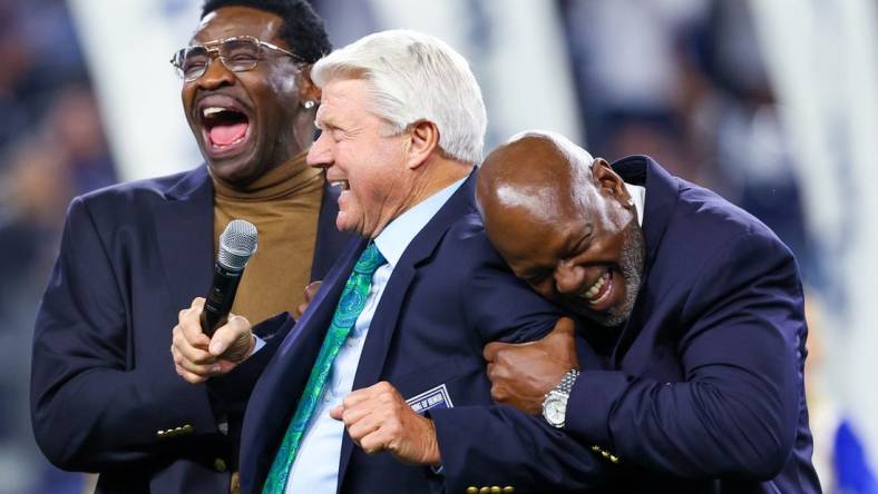 Dec 30, 2023; Arlington, Texas, USA;  Dallas Cowboys former head coach Jimmy Johnson celebrates with former players Michael Irvin and Emmitt Smith after being inducted into the ring of honor at halftime of the game against the Detroit Lions at AT&T Stadium. Mandatory Credit: Kevin Jairaj-USA TODAY Sports
