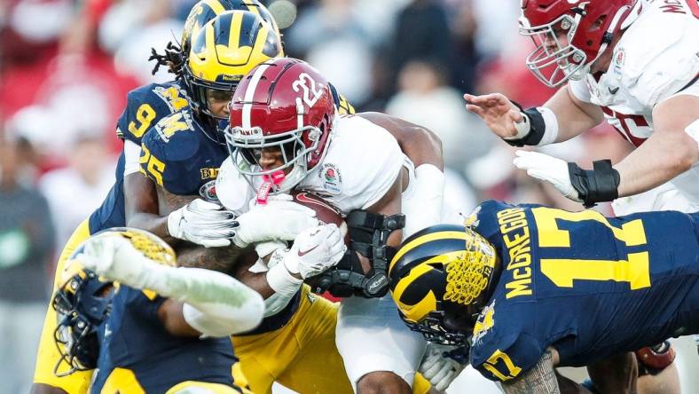 Alabama running back Justice Haynes (22) runs against Michigan defensive end Braiden McGregor (17) during the second half of the Rose Bowl in Pasadena, Calif., on Monday, Jan. 1, 2024.